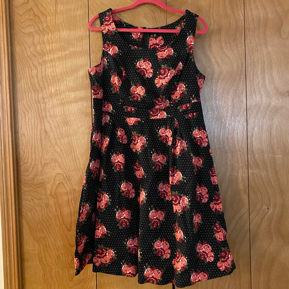 Torrid black polka dot dress with flower accents.